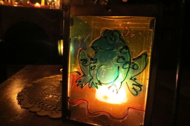 Mr. Frog, all aglow in the candlelight.