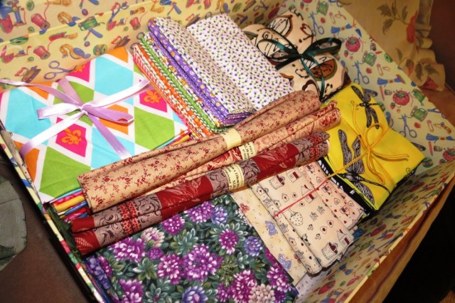 Quilting 'fat-quarters" all neatly arranged in a sewing storage box.